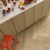 spc-flooring-herringone-quick-step-ciro-botanic-beige SPC flooring herringbone Quick Step Ciro Botanic Beige installed on Kitchen floor