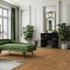 herringbone-parquet-oak-mix-140mm-beveled-brushed-oilwaxed Classical living room with herringbone parquet, marble fireplace, green sofa